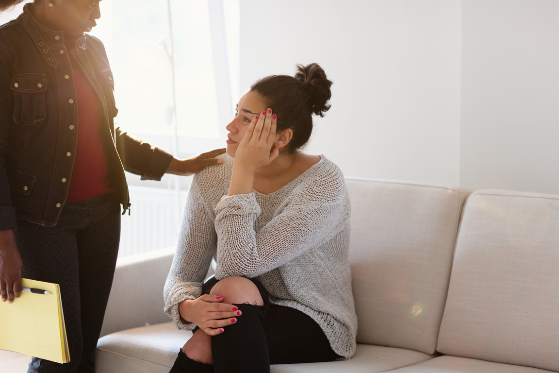 Psychotherapy:  Mental health professional consoling patient